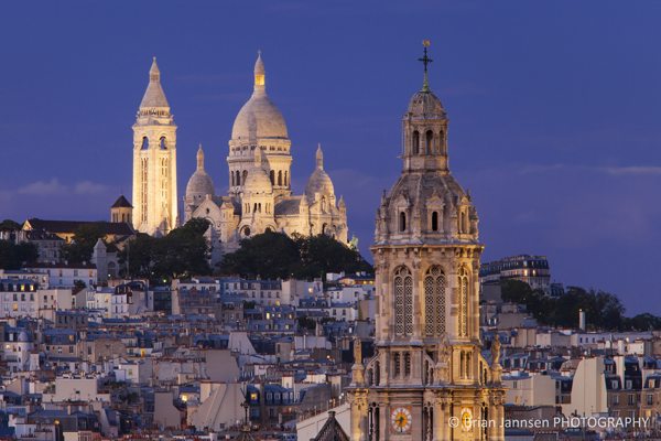 Tower of Trinite d' Estienne d' Orves Church with Sacre Coeur at twilight, Paris France